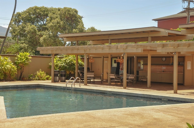 view of swimming pool with a patio and a pergola