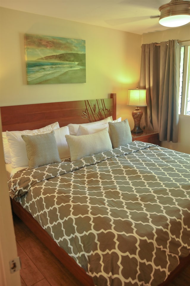 bedroom with wood-type flooring and ceiling fan