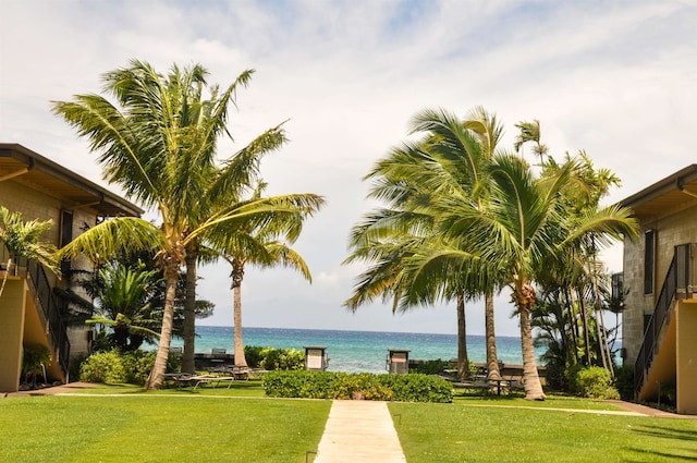 view of property's community with a yard and a water view