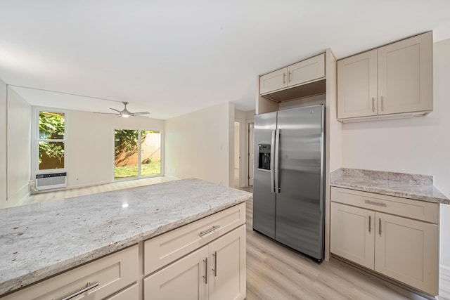 kitchen featuring stainless steel fridge, ceiling fan, light stone counters, cooling unit, and light wood-style floors