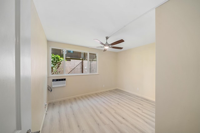 unfurnished room with a ceiling fan, baseboards, wood finished floors, and a wall mounted air conditioner