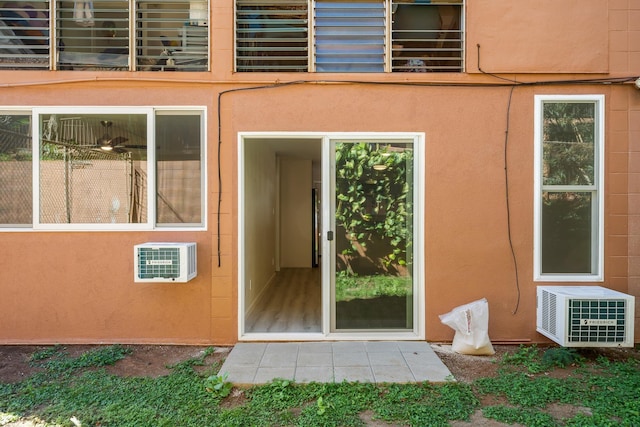 property entrance with stucco siding