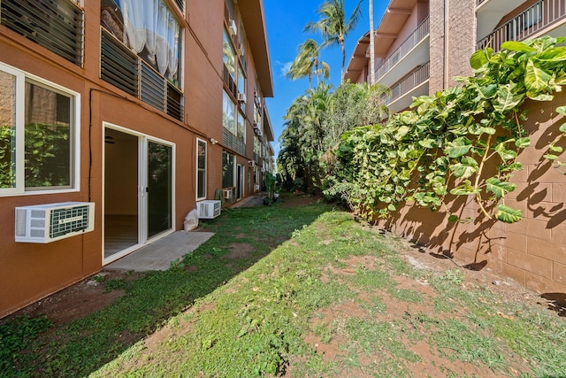 view of yard featuring a wall unit AC