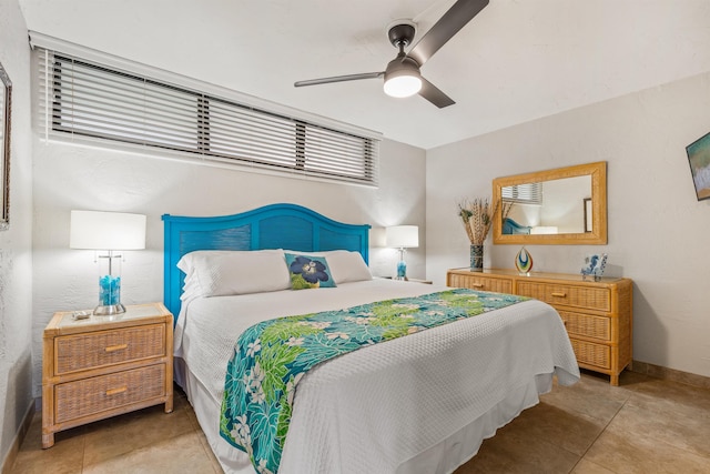 bedroom with a ceiling fan and baseboards