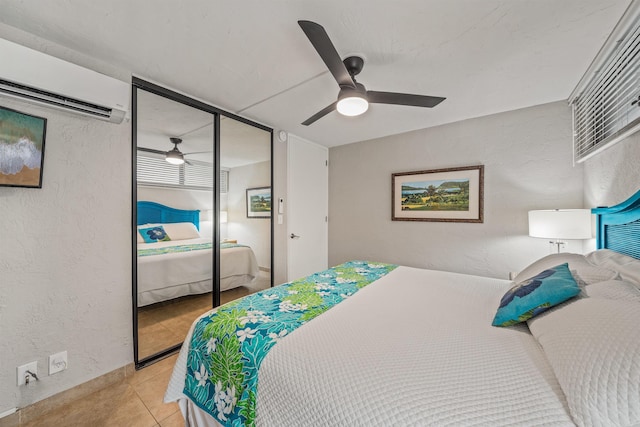 bedroom featuring a closet, an AC wall unit, and a textured wall