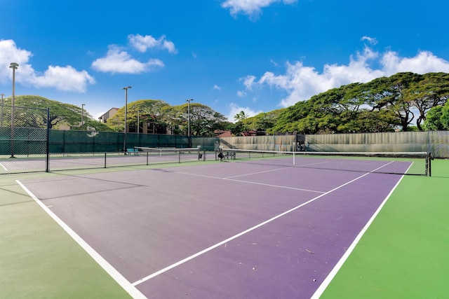 view of sport court with fence