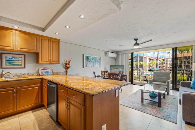 kitchen with open floor plan, a peninsula, a wall mounted AC, and light stone countertops