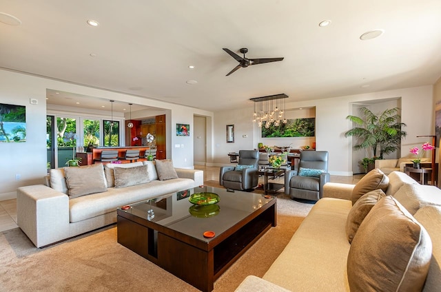 carpeted living room with ceiling fan with notable chandelier