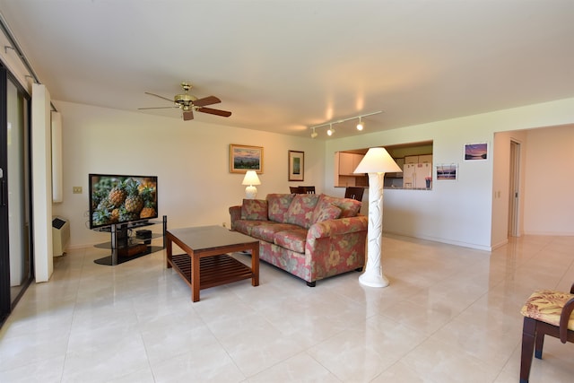 tiled living room featuring rail lighting and ceiling fan