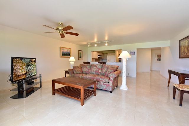 tiled living room featuring rail lighting and ceiling fan