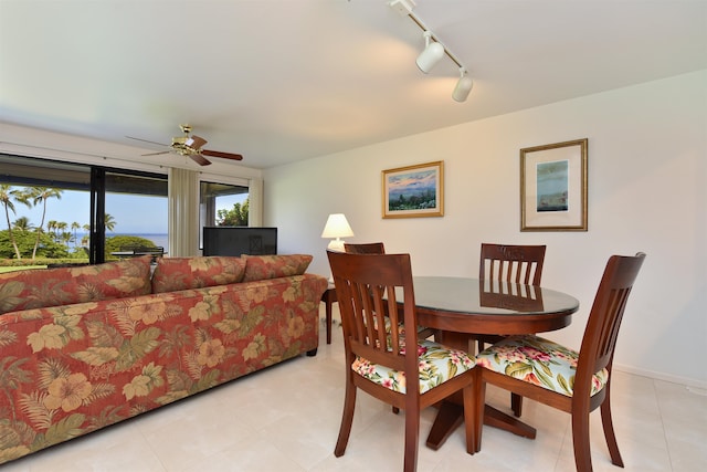 dining area featuring rail lighting, ceiling fan, and light tile patterned flooring