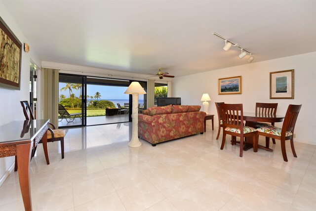 living room with rail lighting, ceiling fan, and light tile patterned flooring