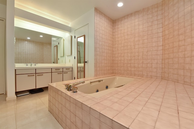 bathroom featuring tile patterned floors, tile walls, tiled tub, and vanity