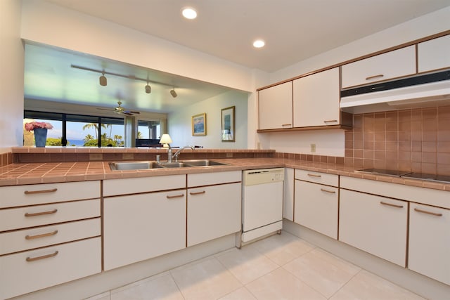 kitchen featuring ceiling fan, dishwasher, tile counters, and light tile patterned flooring