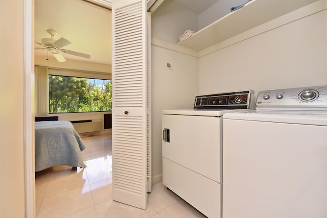 laundry room featuring washing machine and dryer, ceiling fan, and light tile patterned floors