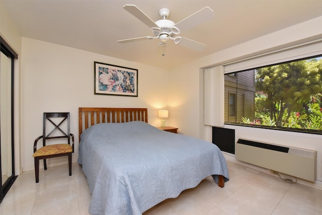 bedroom with radiator, light tile patterned flooring, and ceiling fan