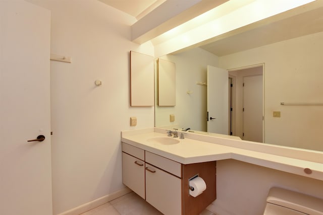 bathroom with tile patterned flooring, toilet, and vanity