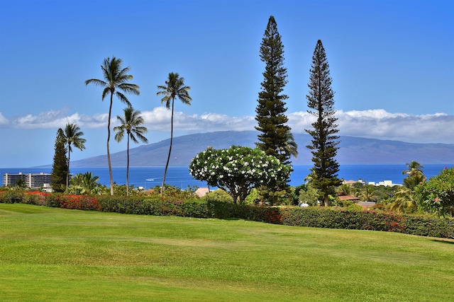 surrounding community featuring a lawn and a water and mountain view