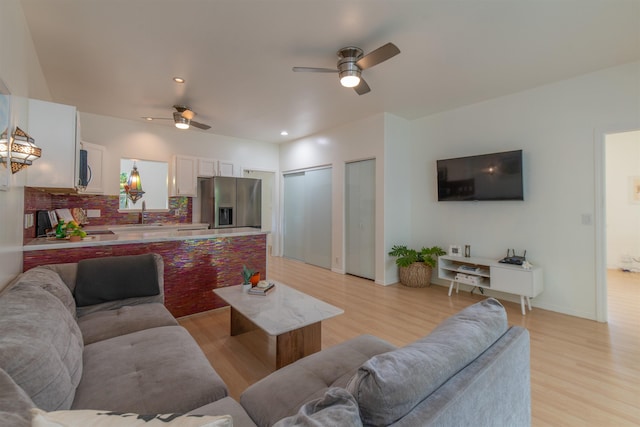 568 Hana Hwy Unit B, Paia, HI 96779 - living room with light wood-style floors, ceiling fan, baseboards, and recessed lighting
