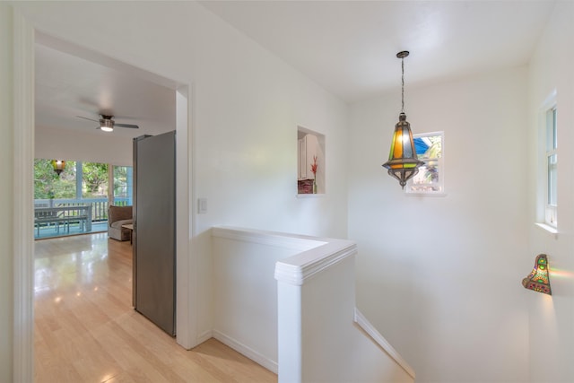 568 Hana Hwy Unit B, Paia, HI 96779 - hallway featuring an upstairs landing, light wood finished floors, and baseboards