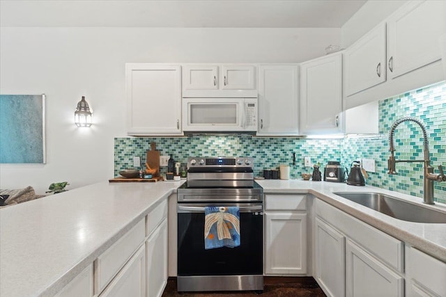 568 Hana Hwy Unit B, Paia, HI 96779 - kitchen featuring stainless steel range with electric stovetop, white microwave, a sink, light countertops, and white cabinets