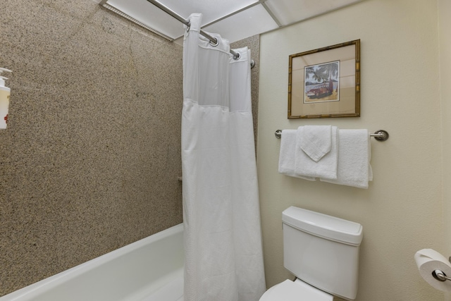 bathroom with shower / bath combination with curtain and toilet