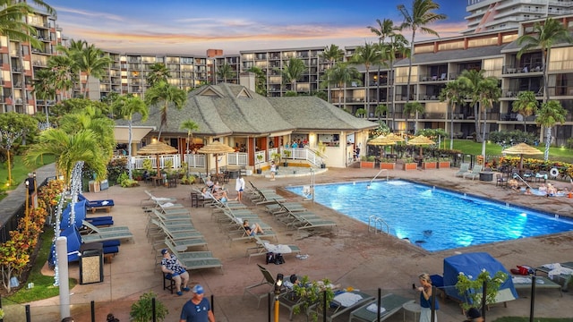 pool at dusk with a patio