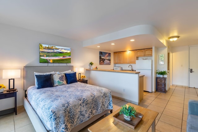 tiled bedroom featuring white refrigerator and sink