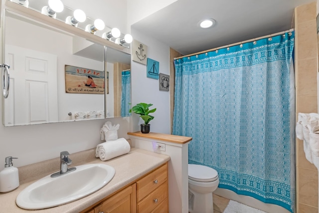 bathroom featuring tile flooring, toilet, and vanity