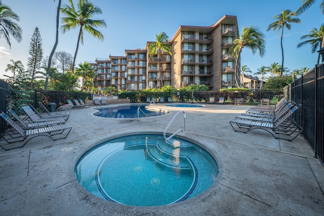 view of pool featuring a hot tub and a patio