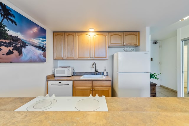 kitchen featuring white appliances, light brown cabinetry, sink, and light tile flooring