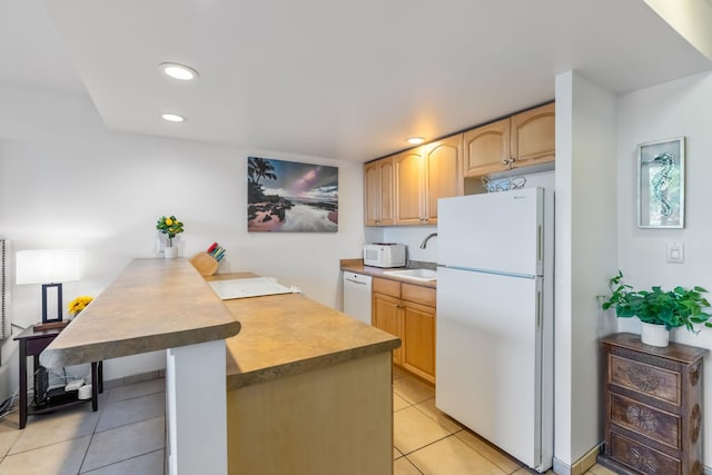 kitchen featuring light brown cabinetry, white appliances, sink, and light tile floors