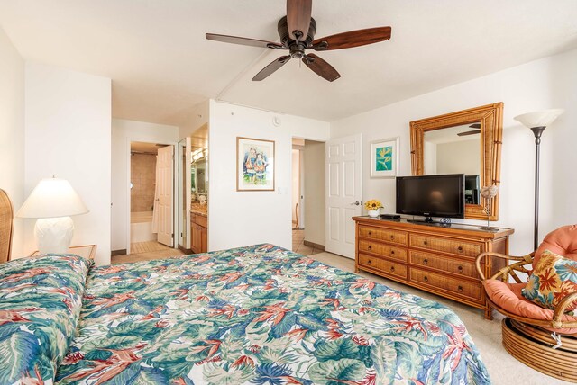 bedroom featuring ceiling fan, light tile patterned floors, and ensuite bath