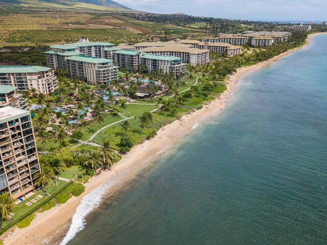 drone / aerial view with a beach view and a water view