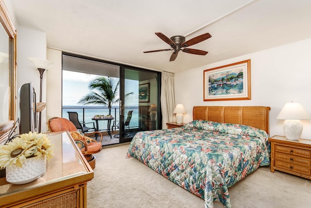 bedroom with expansive windows, ceiling fan, carpet, and access to exterior