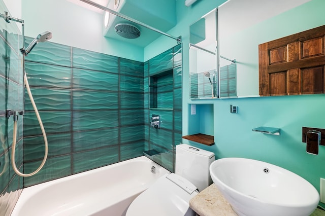 bathroom featuring toilet, bathtub / shower combination, and a sink