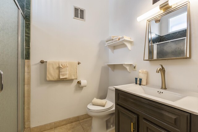 bathroom with tile patterned floors and a shower with door