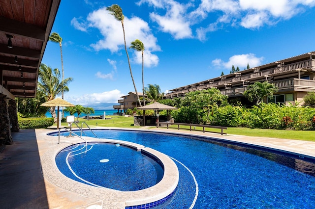 view of swimming pool with a gazebo and a water view