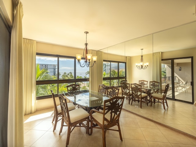 dining room with an inviting chandelier and light tile patterned floors