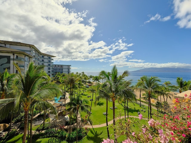 surrounding community featuring a lawn and a water and mountain view