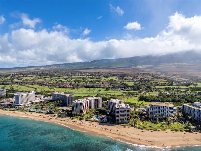 birds eye view of property with a water and mountain view and a beach view