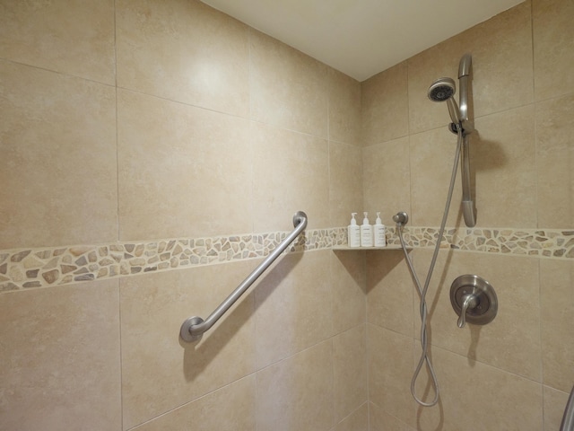 bathroom with tiled shower