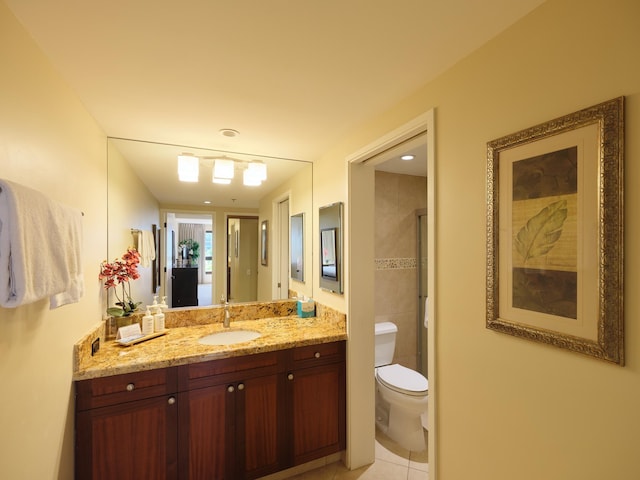 bathroom with toilet, tile patterned flooring, and vanity