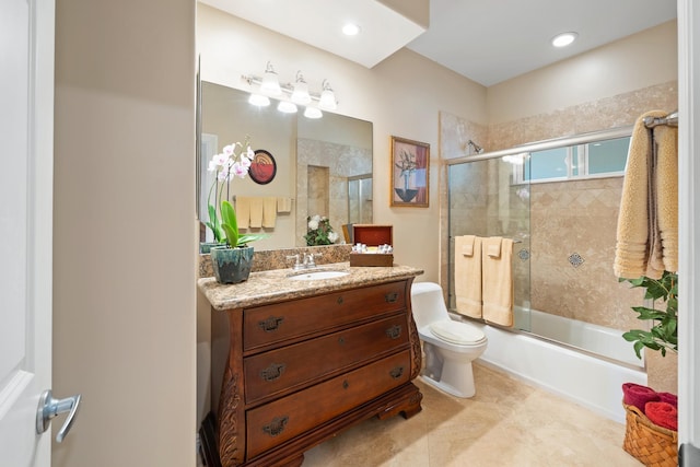 full bathroom featuring toilet, vanity, and combined bath / shower with glass door