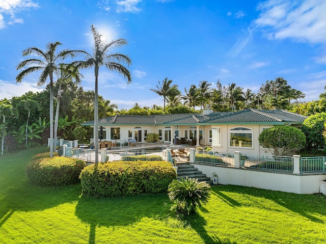 back of property with a patio area, a yard, and an outdoor hangout area