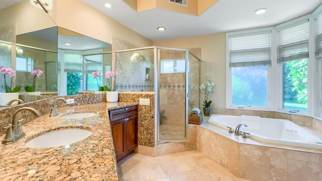 bathroom with tile patterned flooring, vanity, and separate shower and tub