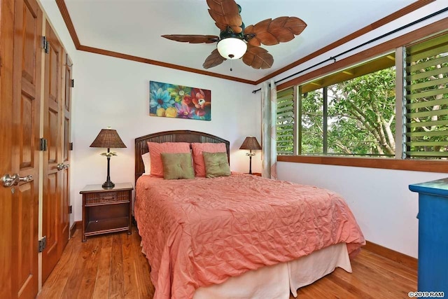 bedroom featuring ornamental molding, wood finished floors, and baseboards