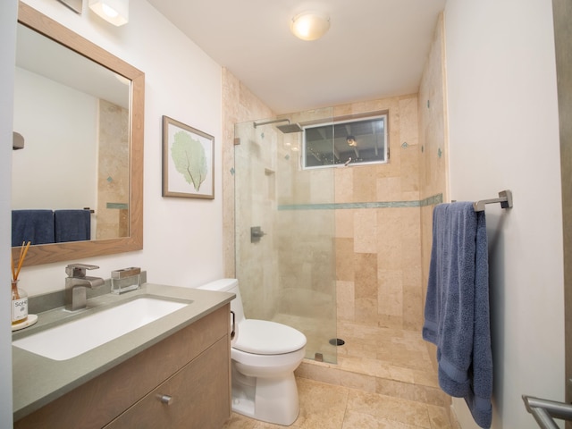 bathroom with a shower with shower door, vanity, toilet, and tile patterned flooring