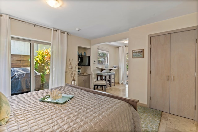 bedroom featuring access to exterior and light tile patterned floors