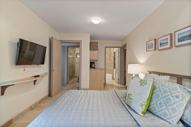 bedroom with light tile patterned floors and ensuite bath